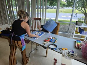 Amanda doing splatter painting with Wendy.